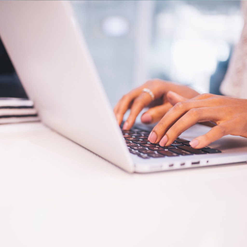 Image of a person typing on a laptop