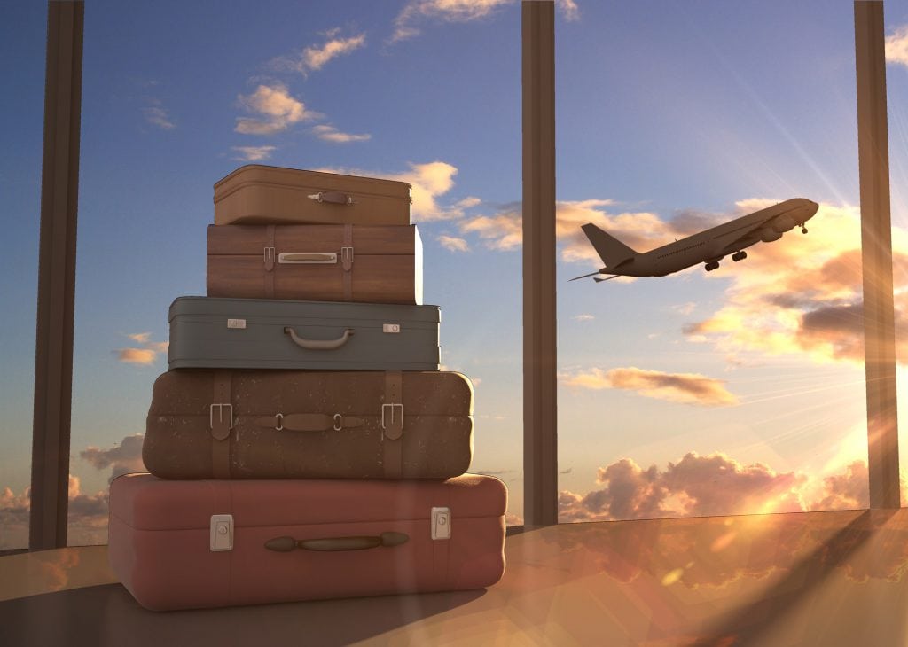 Travel bags and airplane in sky signifying locum tenens