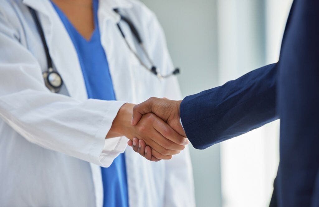 Handshake between physician and hospital administration professional